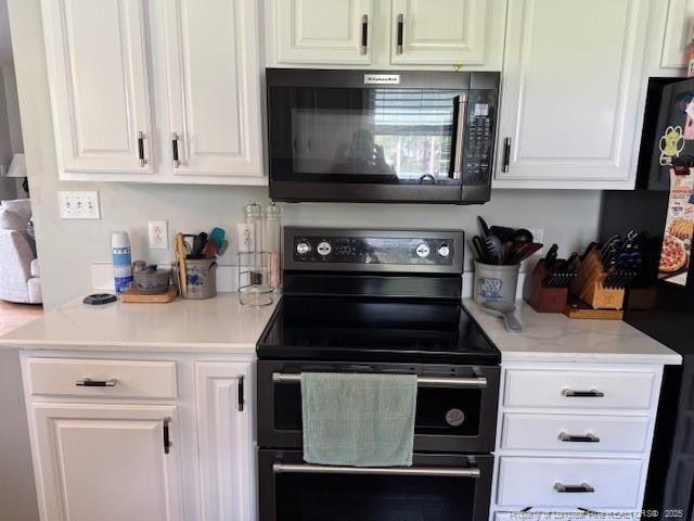 49 Pebble Beach Pt, Sanford, NC 27332 - kitchen featuring black appliances and white cabinetry