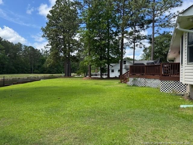 49 Pebble Beach Pt, Sanford, NC 27332 - view of green lawn featuring a deck