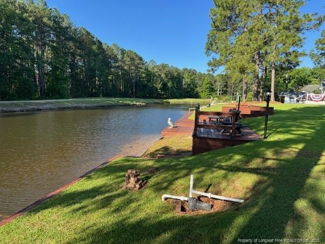 49 Pebble Beach Pt, Sanford, NC 27332 - dock featuring a water view, a lawn, and a forest view