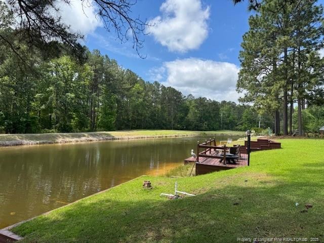49 Pebble Beach Pt, Sanford, NC 27332 - dock area with a water view, a wooded view, and a lawn