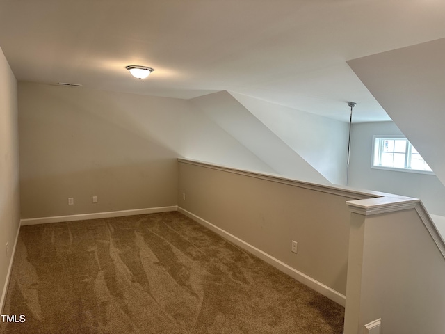 bonus room with carpet floors, lofted ceiling, and baseboards