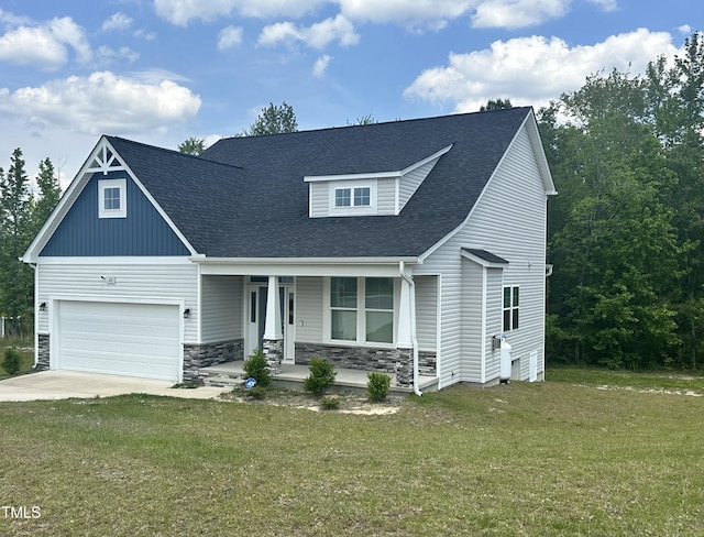 craftsman house featuring covered porch, roof with shingles, a front lawn, stone siding, and driveway