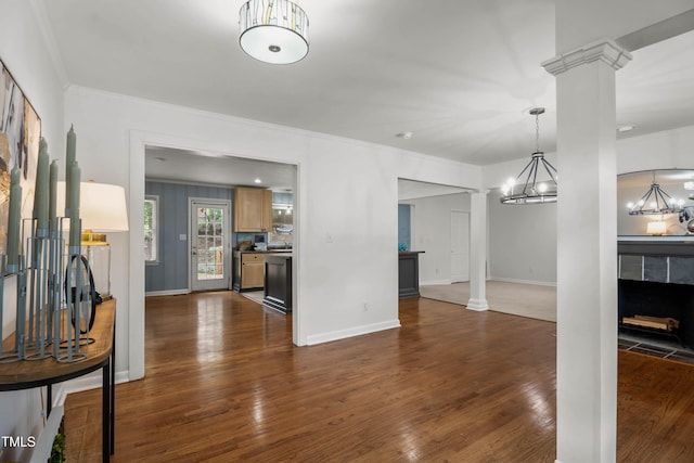 334 Westview Dr, Fayetteville, NC 28303 - unfurnished living room with decorative columns, ornamental molding, dark wood-style floors, baseboards, and a tile fireplace