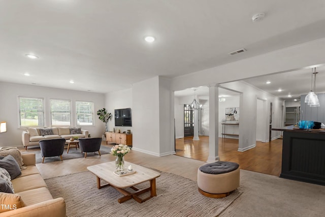 334 Westview Dr, Fayetteville, NC 28303 - living area with decorative columns, light wood-type flooring, recessed lighting, baseboards, and a chandelier