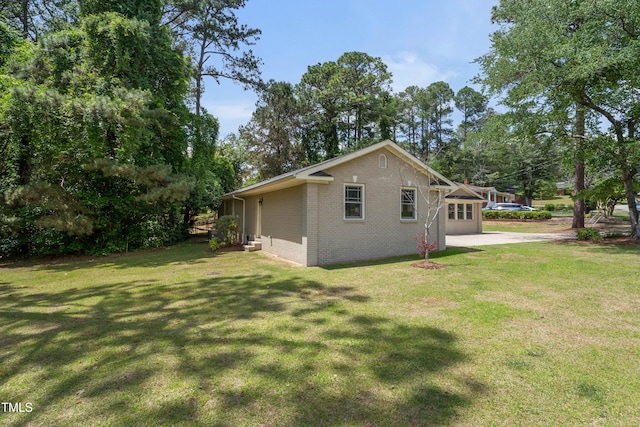 334 Westview Dr, Fayetteville, NC 28303 - view of side of home featuring brick siding and a yard