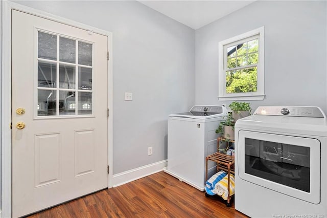 laundry area with wood finished floors, separate washer and dryer, and baseboards