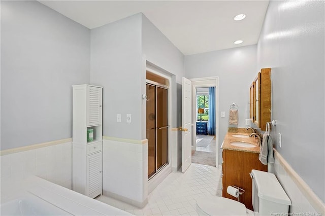 full bath featuring tile patterned floors, a shower stall, toilet, double vanity, and recessed lighting