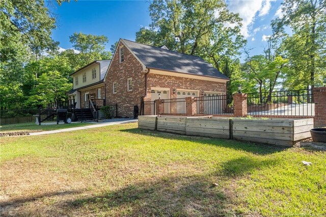 view of side of home featuring brick siding and a garage