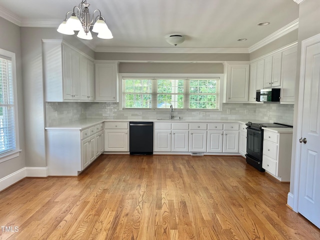 4016 Berman Edge Rd, Holly Springs, NC 27540 - kitchen with black / electric stove, dishwashing machine, a sink, light countertops, and a chandelier