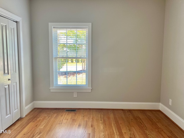 4016 Berman Edge Rd, Holly Springs, NC 27540 - empty room featuring baseboards, light wood-type flooring, and plenty of natural light
