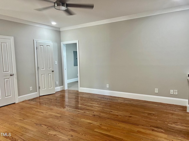 4016 Berman Edge Rd, Holly Springs, NC 27540 - unfurnished bedroom featuring crown molding, electric panel, wood finished floors, baseboards, and ceiling fan
