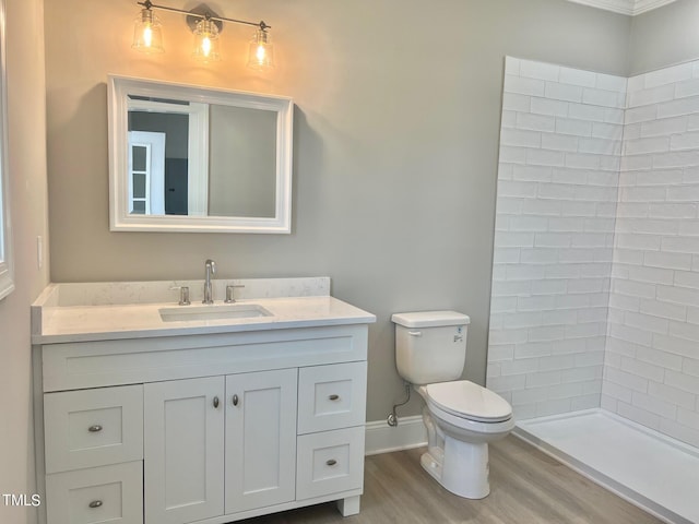 4016 Berman Edge Rd, Holly Springs, NC 27540 - bathroom featuring wood finished floors, vanity, toilet, a tile shower, and baseboards