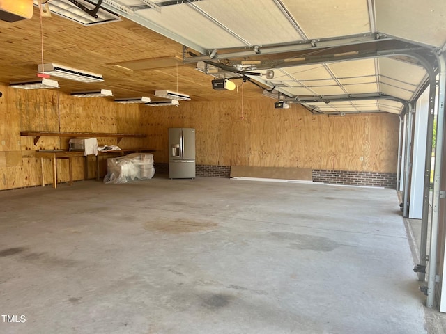 4016 Berman Edge Rd, Holly Springs, NC 27540 - garage with stainless steel fridge, wood walls, and a garage door opener