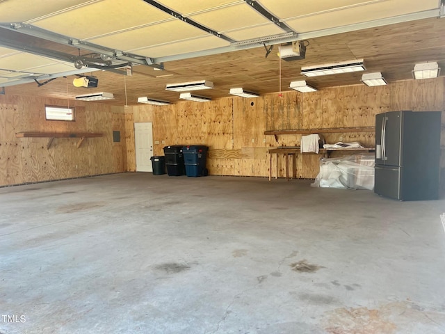 4016 Berman Edge Rd, Holly Springs, NC 27540 - garage featuring stainless steel fridge with ice dispenser, wooden walls, and a garage door opener