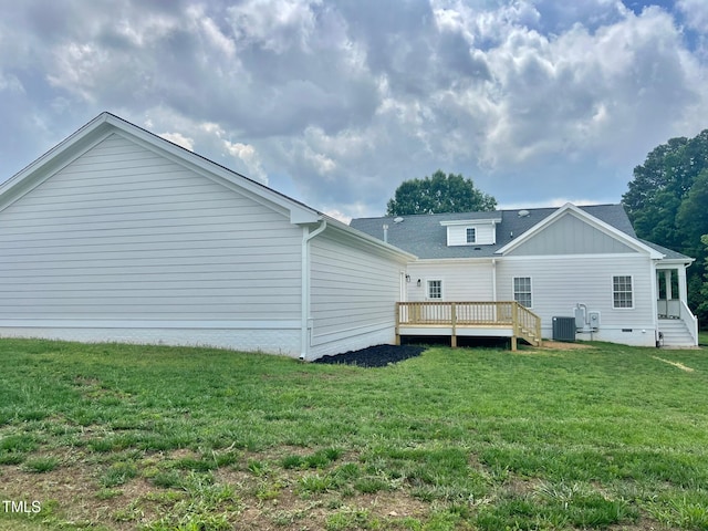 4016 Berman Edge Rd, Holly Springs, NC 27540 - rear view of house featuring central AC unit, a deck, a lawn, and board and batten siding
