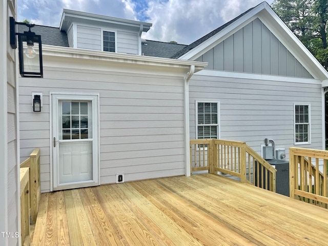 4016 Berman Edge Rd, Holly Springs, NC 27540 - back of property with a deck, roof with shingles, board and batten siding, and central air condition unit
