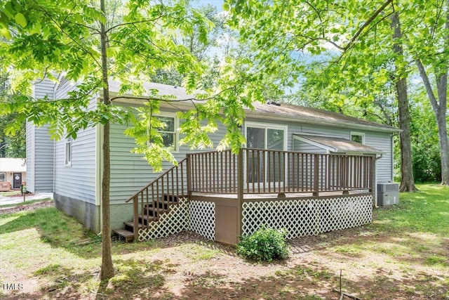 back of property with a deck, cooling unit, and stairs