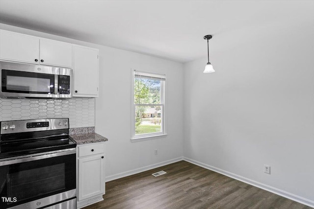kitchen featuring stainless steel appliances, dark wood finished floors, white cabinetry, and tasteful backsplash