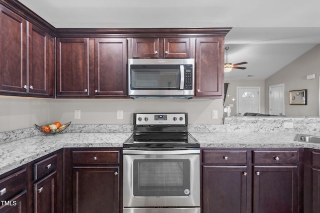 kitchen with appliances with stainless steel finishes, light countertops, a ceiling fan, dark brown cabinets, and a sink