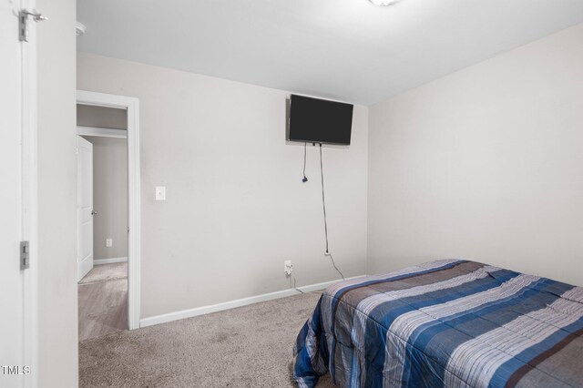 carpeted bedroom featuring baseboards