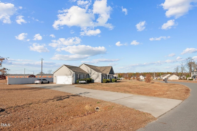 view of yard with a garage and driveway