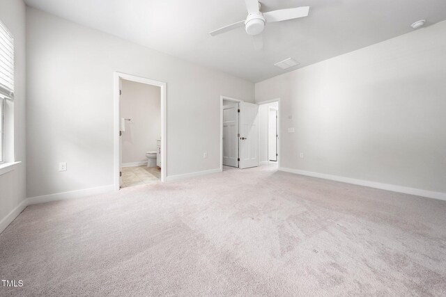 1437 Newpoint Dr, Durham, NC 27713 - unfurnished bedroom with a spacious closet, light carpet, connected bathroom, and baseboards