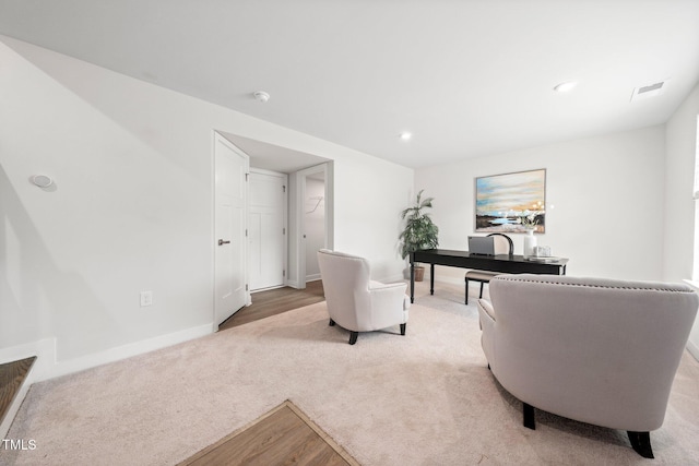 1437 Newpoint Dr, Durham, NC 27713 - living room featuring light colored carpet, baseboards, light wood-type flooring, and recessed lighting
