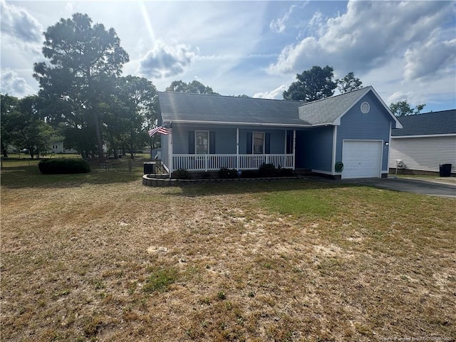 view of front of house featuring a porch, a garage, asphalt driveway, and a front lawn