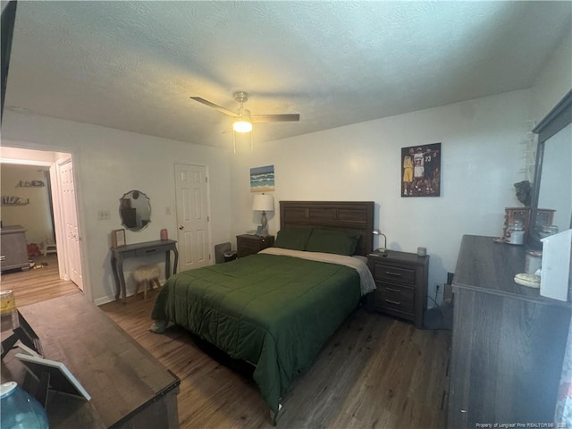 bedroom featuring wood finished floors, a ceiling fan, and a textured ceiling