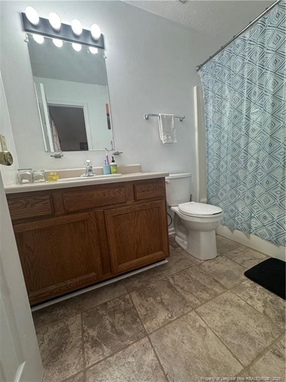 full bathroom featuring toilet, vanity, and a shower with curtain