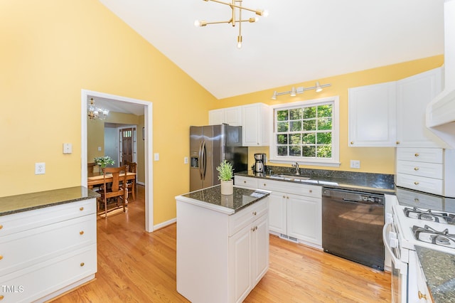 kitchen with black dishwasher, a chandelier, stainless steel fridge, a sink, and gas range gas stove