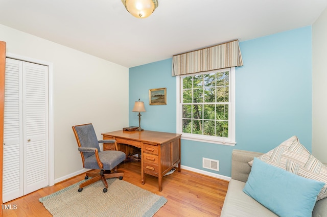 office with light wood-style flooring and baseboards