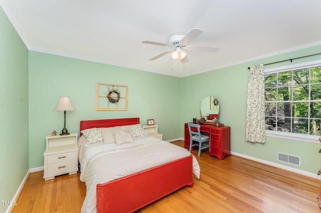 bedroom featuring light wood-style floors, baseboards, ornamental molding, and ceiling fan