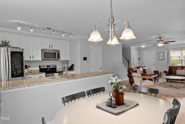 100 Stratford Lakes Dr Unit 361, Durham, NC 27713 - dining space with stairs, light wood-type flooring, a ceiling fan, and baseboards