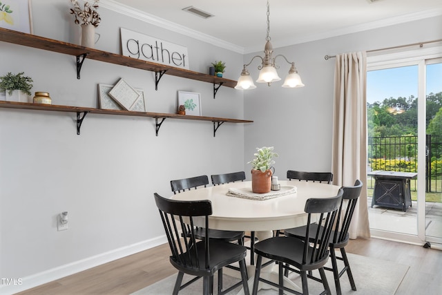 100 Stratford Lakes Dr Unit 361, Durham, NC 27713 - dining room featuring light wood-style floors, a chandelier, ornamental molding, and baseboards