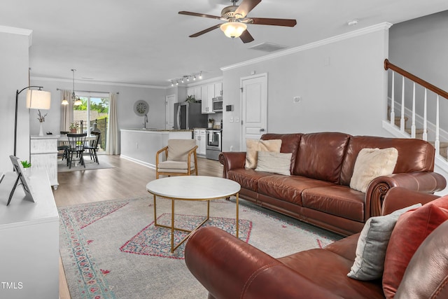 100 Stratford Lakes Dr Unit 361, Durham, NC 27713 - living room featuring ornamental molding, ceiling fan, wood finished floors, stairway, and baseboards