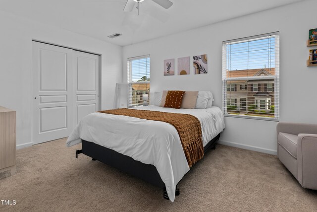 100 Stratford Lakes Dr Unit 361, Durham, NC 27713 - bedroom featuring light colored carpet, baseboards, a closet, and a ceiling fan