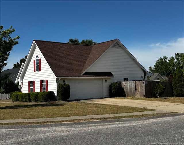 2500 Forest Lodge Dr, Fayetteville, NC 28306 - view of front of home with driveway, an attached garage, and a shingled roof