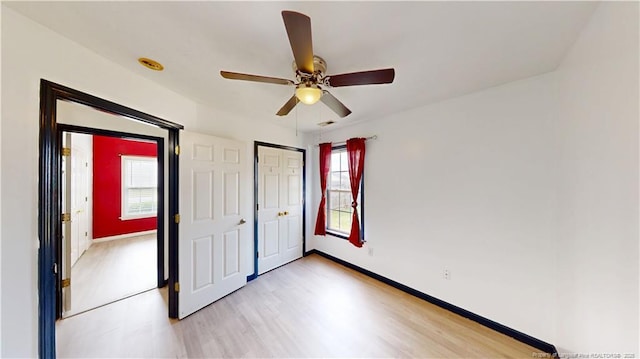 2500 Forest Lodge Dr, Fayetteville, NC 28306 - unfurnished bedroom featuring light wood finished floors, baseboards, ceiling fan, and a closet