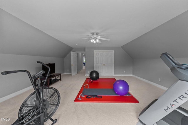 exercise room with carpet, vaulted ceiling, ceiling fan, and baseboards