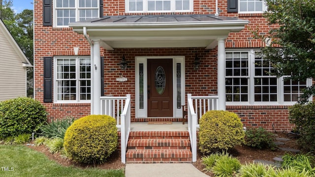 property entrance with brick siding