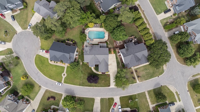 view of property location with nearby suburban area and a pool