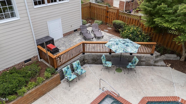 deck featuring a patio area and a fenced backyard