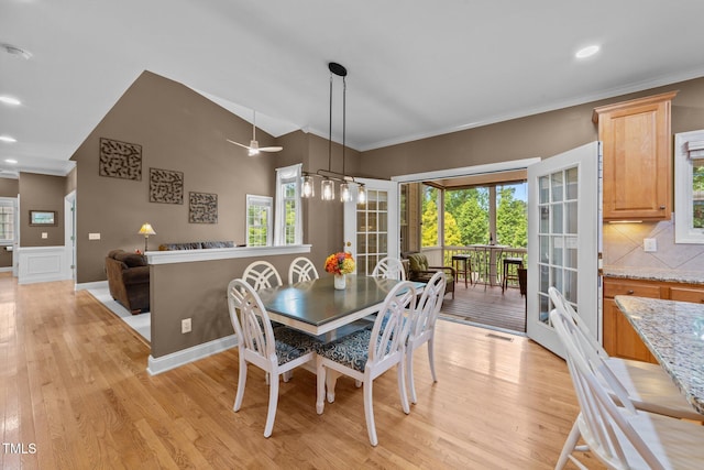 dining area with light wood-style flooring, ornamental molding, a ceiling fan, vaulted ceiling, and recessed lighting