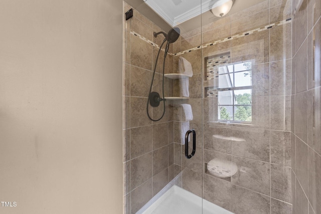 full bath with a shower stall and crown molding