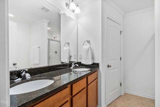 full bath with a shower stall, crown molding, double vanity, baseboards, and tile patterned flooring