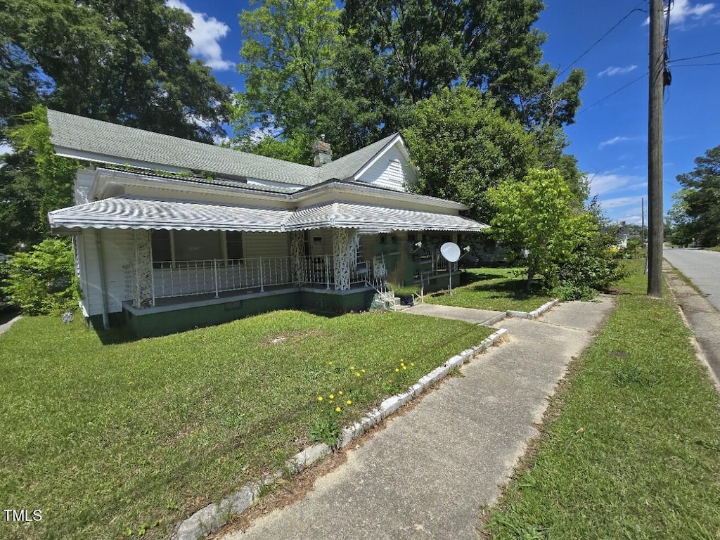824 Beal St, Rocky Mount, NC 27804 - view of front of property with covered porch, a front yard, crawl space, and a chimney
