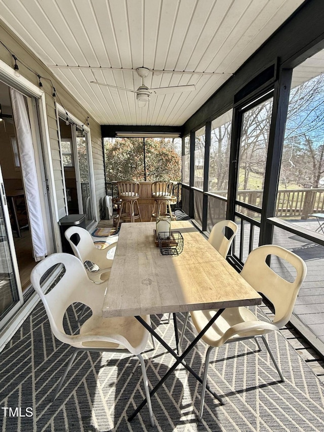 sunroom / solarium featuring outdoor dining area