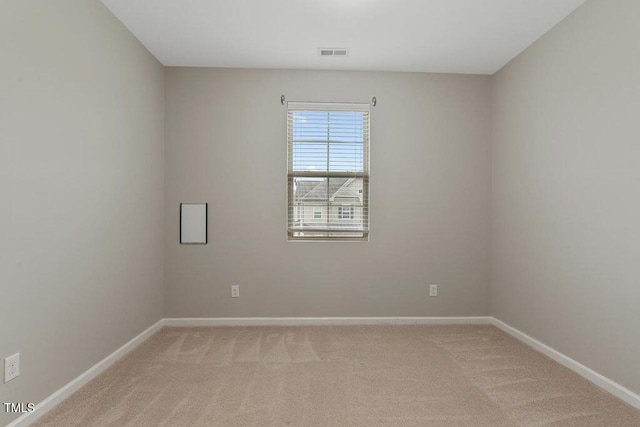 empty room with light carpet and baseboards