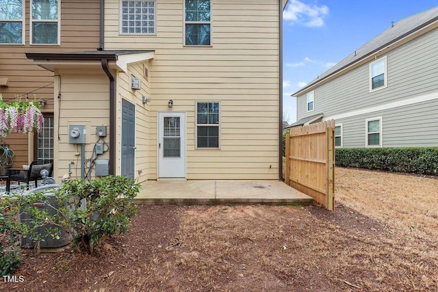 back of property featuring a patio and fence